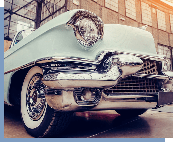 A close up of the front end of an old car