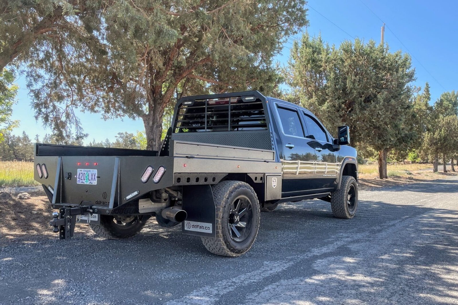 A black truck parked in the middle of a road.